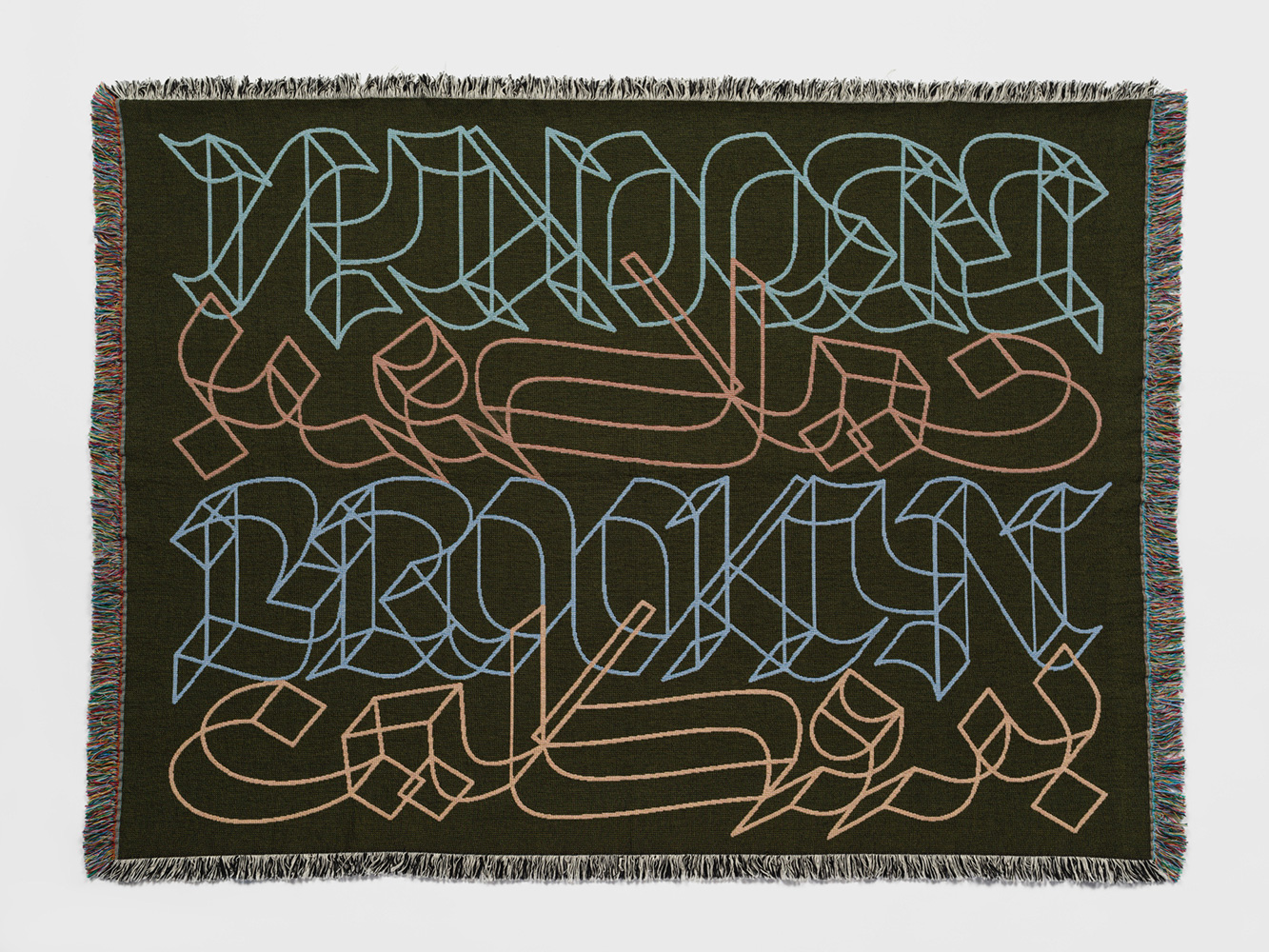Woven tapestry with the word “Brooklyn” in English and Arabic.