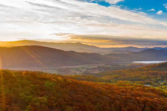 Sunset view of a mountain range during fall foliage.