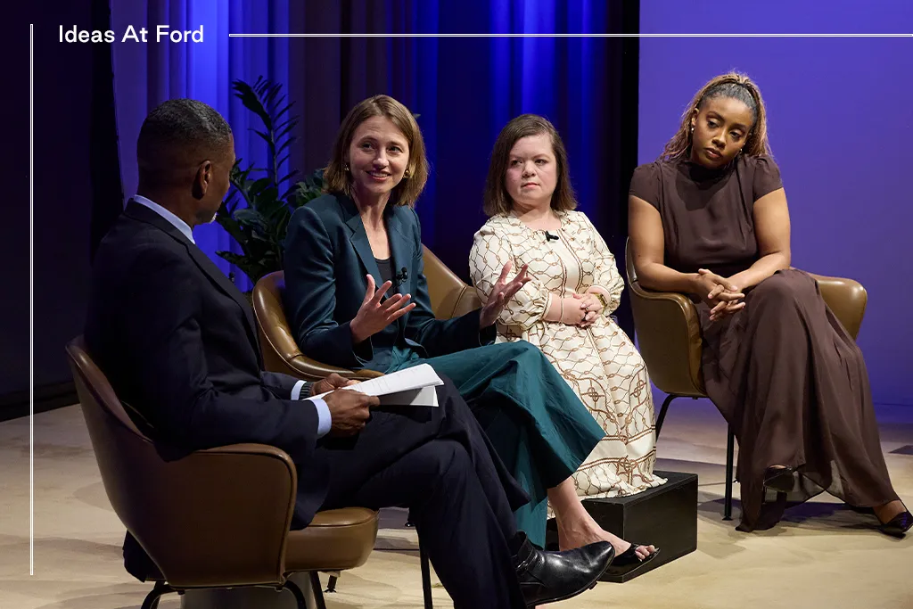 Four people sit on stage in discussion at an event labeled Ideas At Ford. One man, Charles Blow, holds notes while three women, Sara Ziff, Sinéad Burke, and Lindsay Peoples, dressed in formal attire, listen and engage, with one woman gesturing as she speaks.