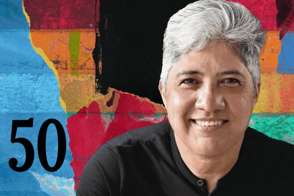 A person with short gray hair and a black shirt smiles in front of a colorful abstract background with the number 50 on the left side.
