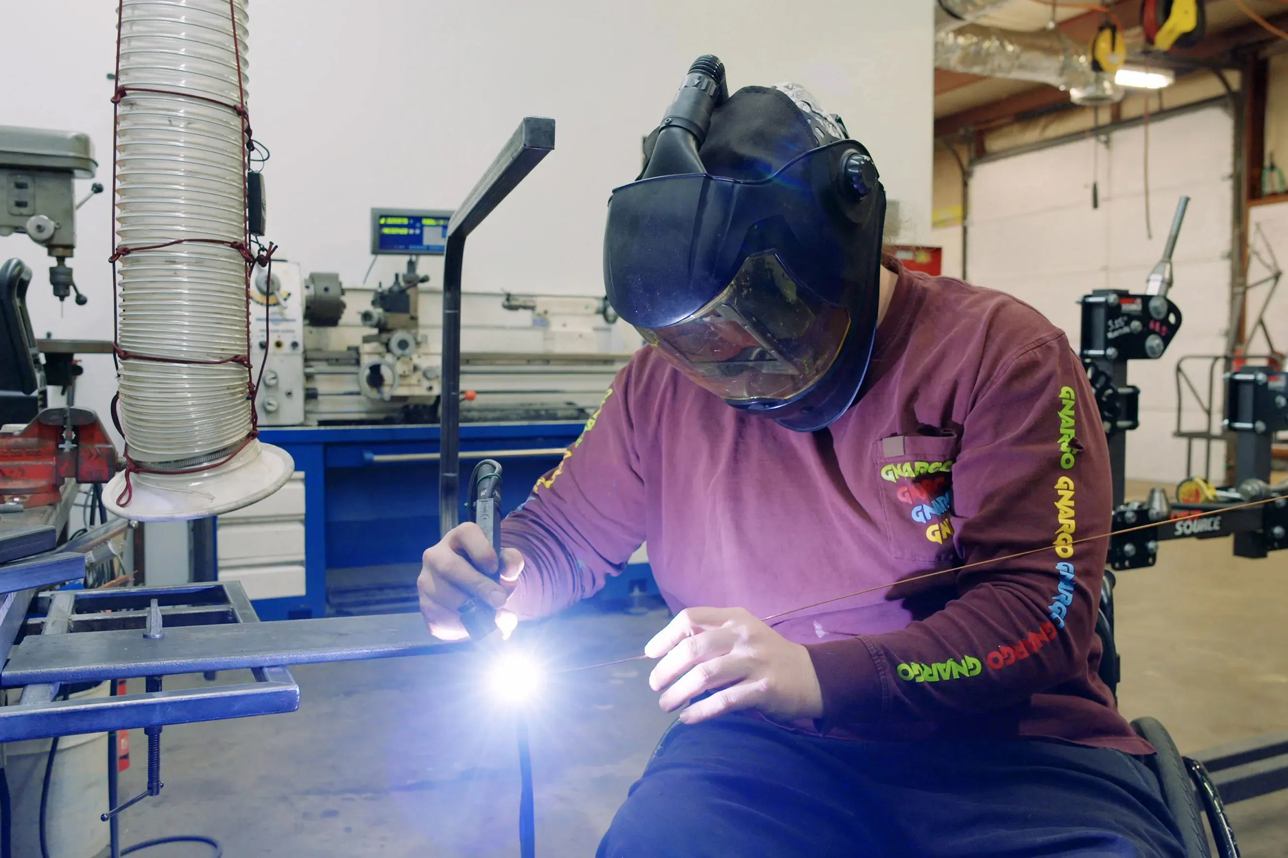 A welder from Gnargo Bike Co welding a piece of metal.