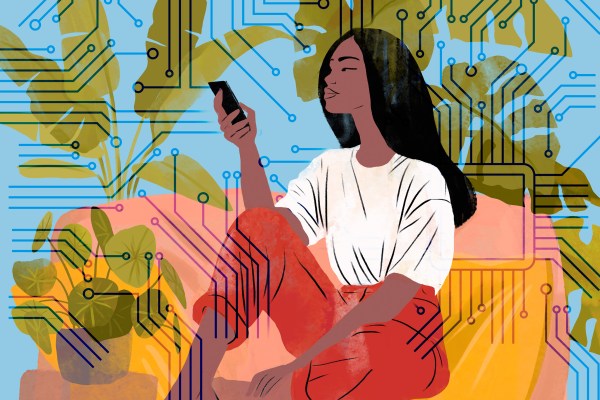 Women sitting looking at her phone with a circuit board in the background.