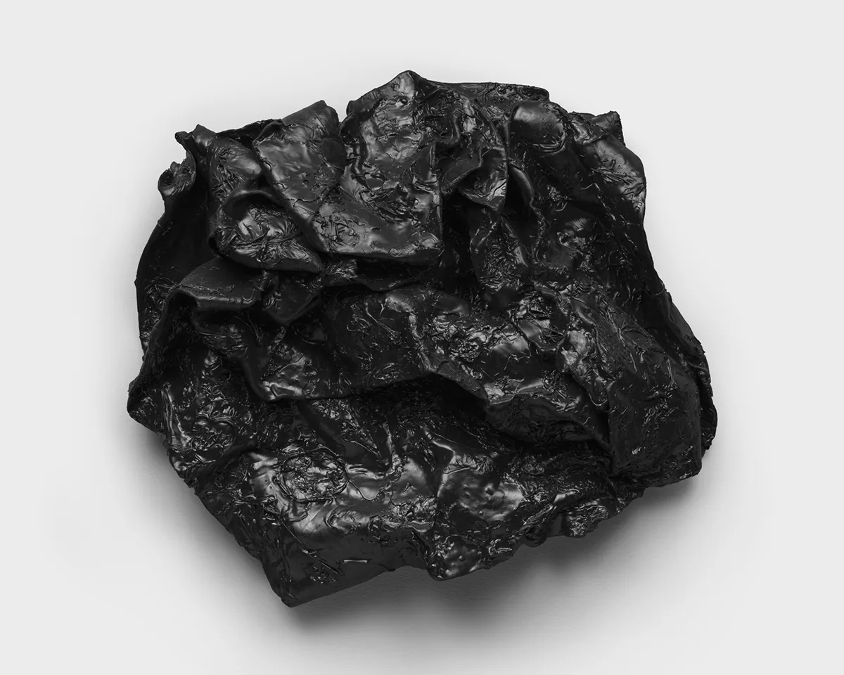 An amorphous sculpture that resembles a rock.