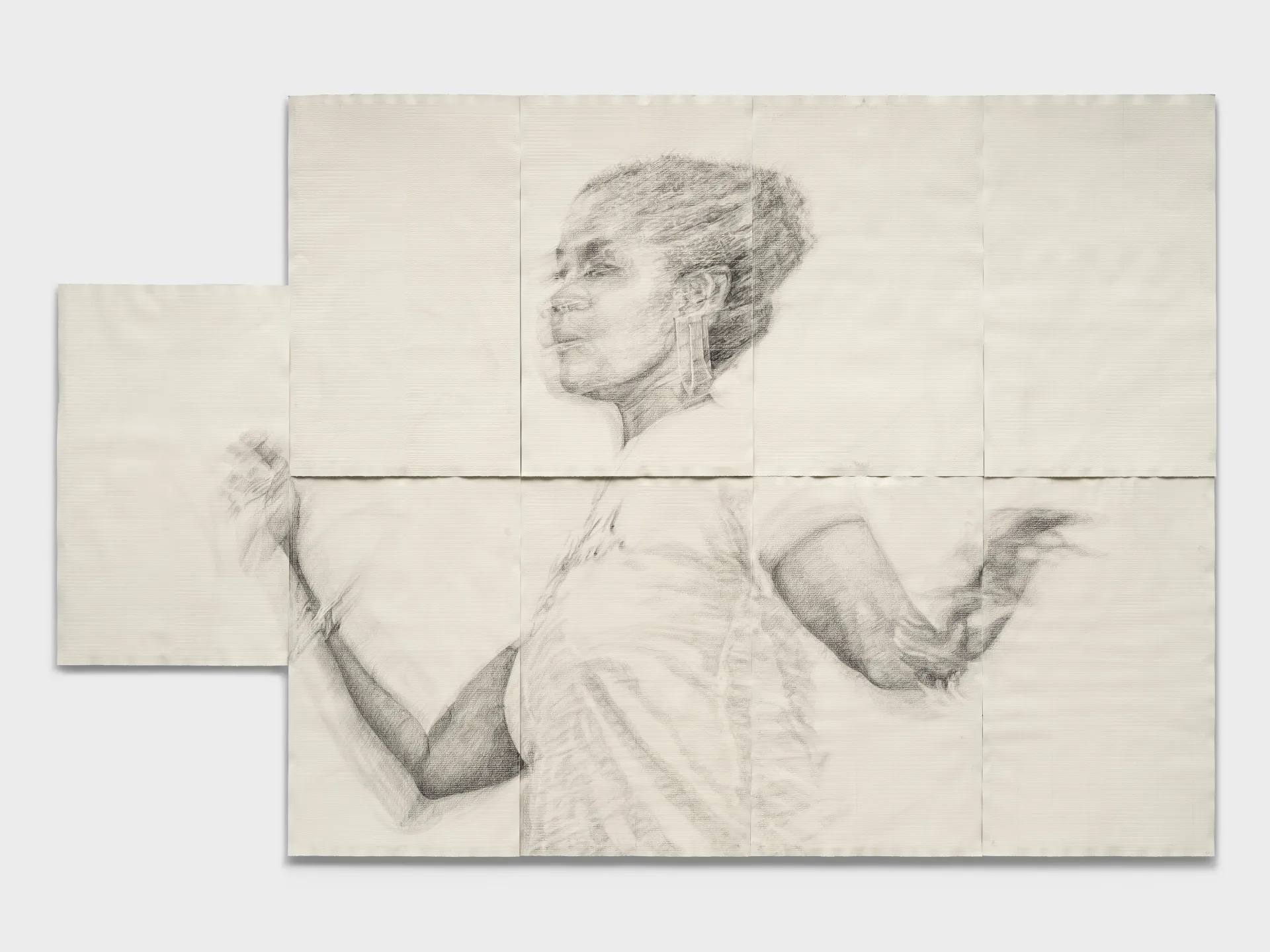A drawing of a Black woman in motion on sheets of large paper.