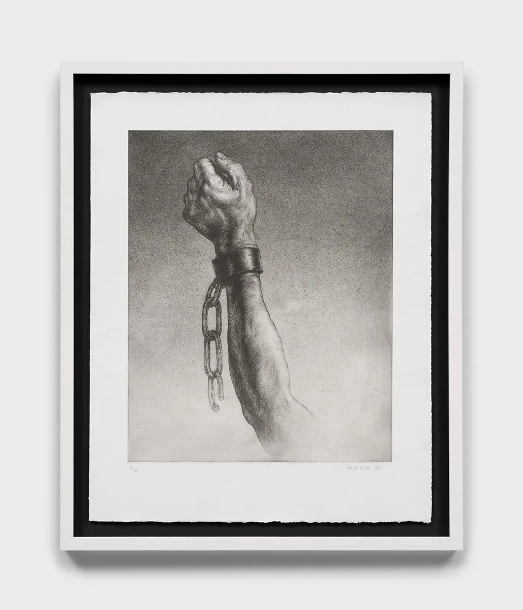 An etching featuring a raised arm broken free from chains.