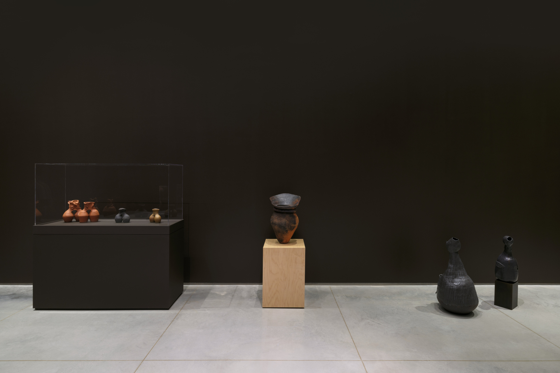 A gallery interior displaying various clay vases and sculptures.
