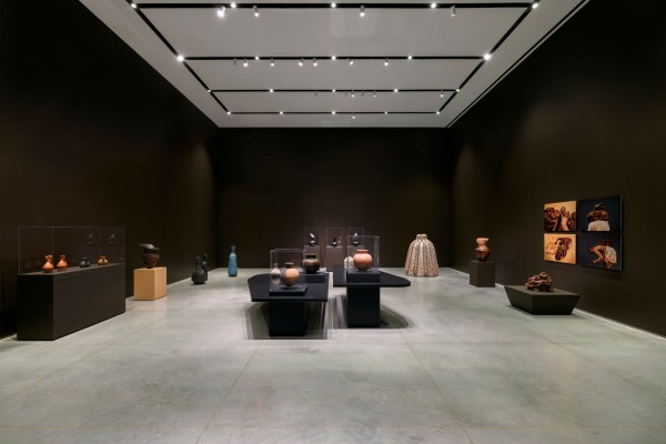 A wide-shot installation view of a gallery exhibition that features artworks relating to clay.