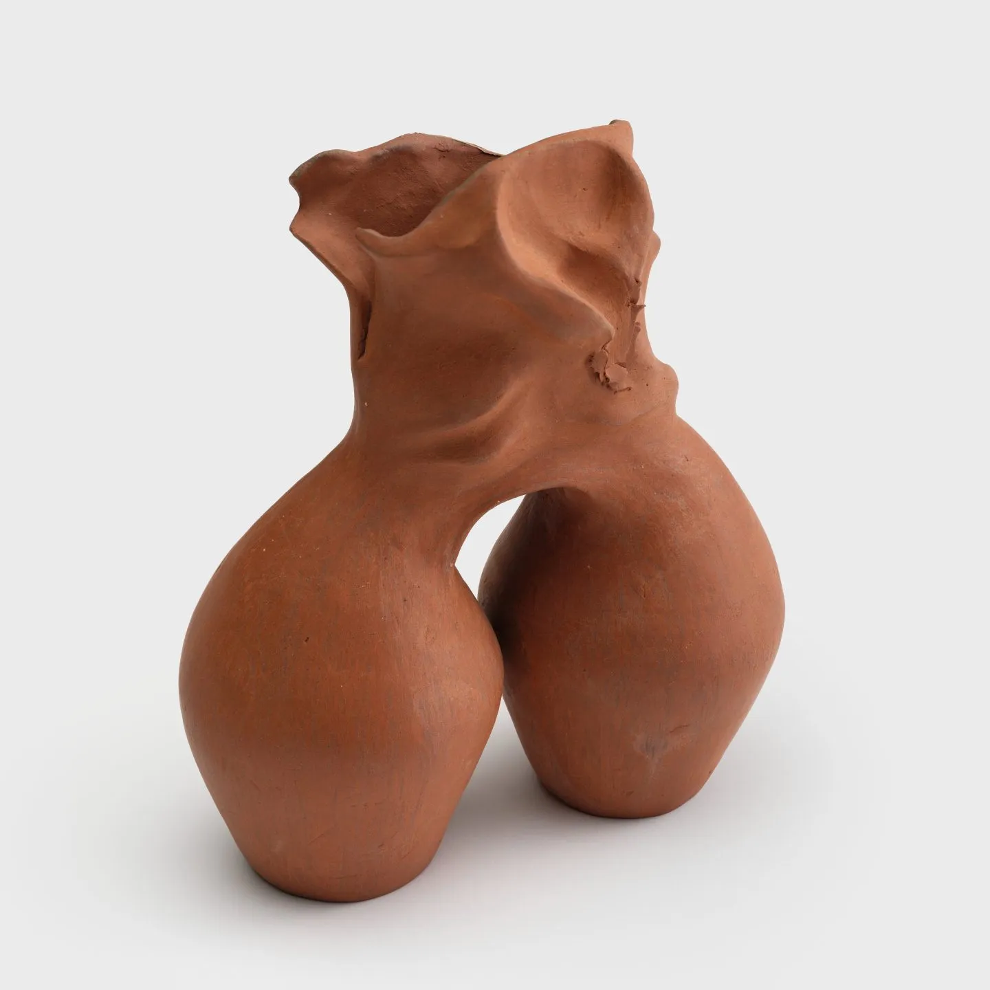 A small ceramic vase with two barrel-shaped bodies connecting at a shared flared neck that has been warped to resemble wrinkled paper.