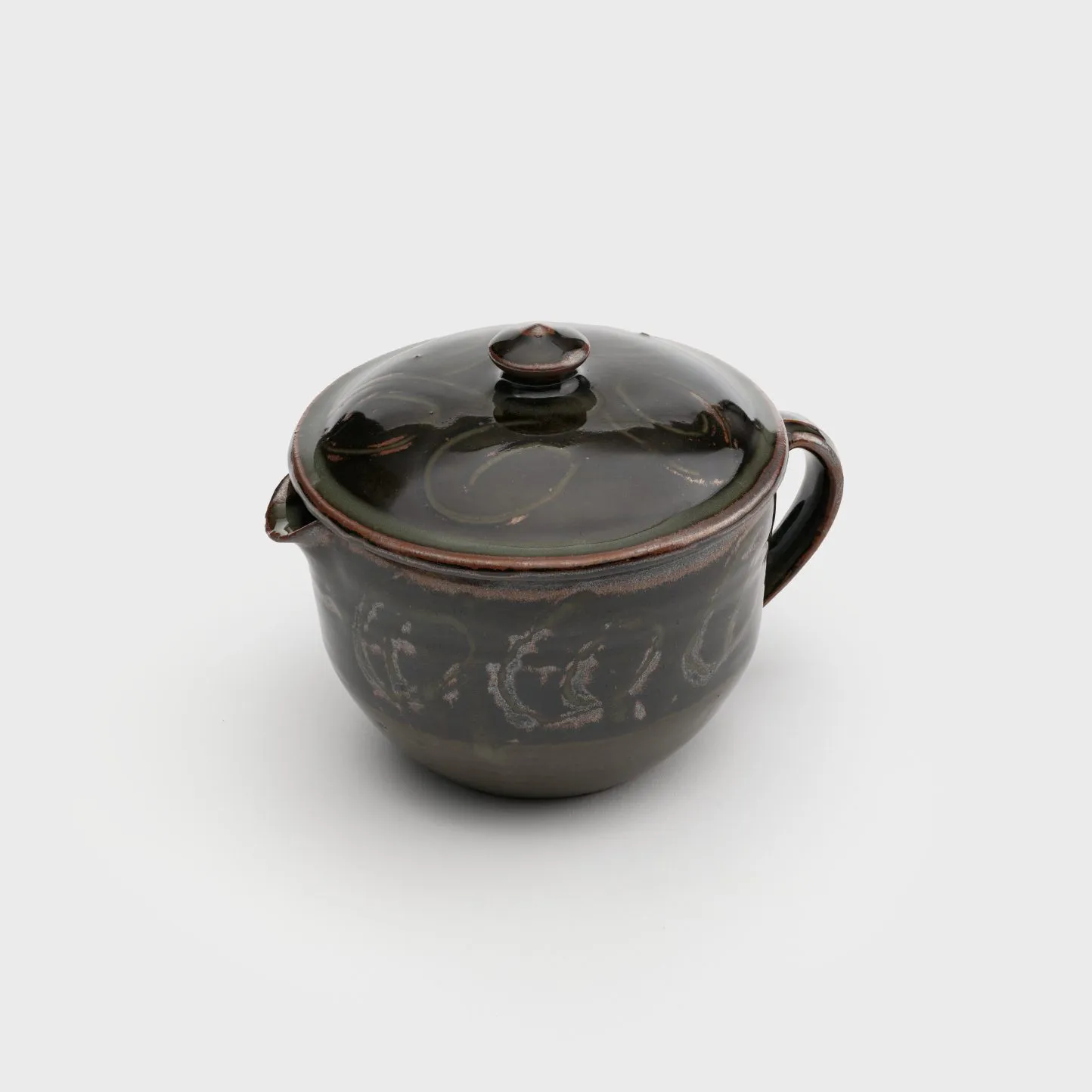 A lidded container with a spout and a rounded handle.
