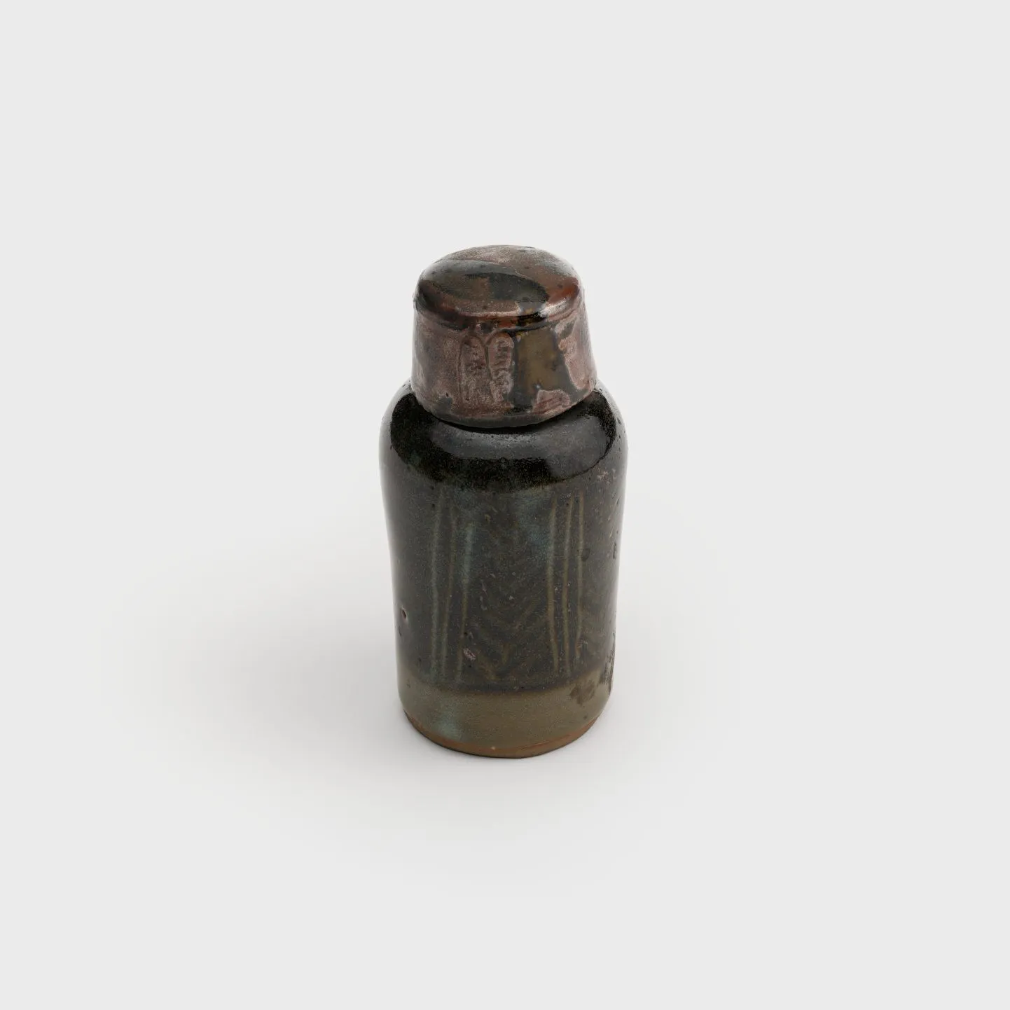 Small ceramic bottle covered with a ceramic lid, like a bottlecap.
