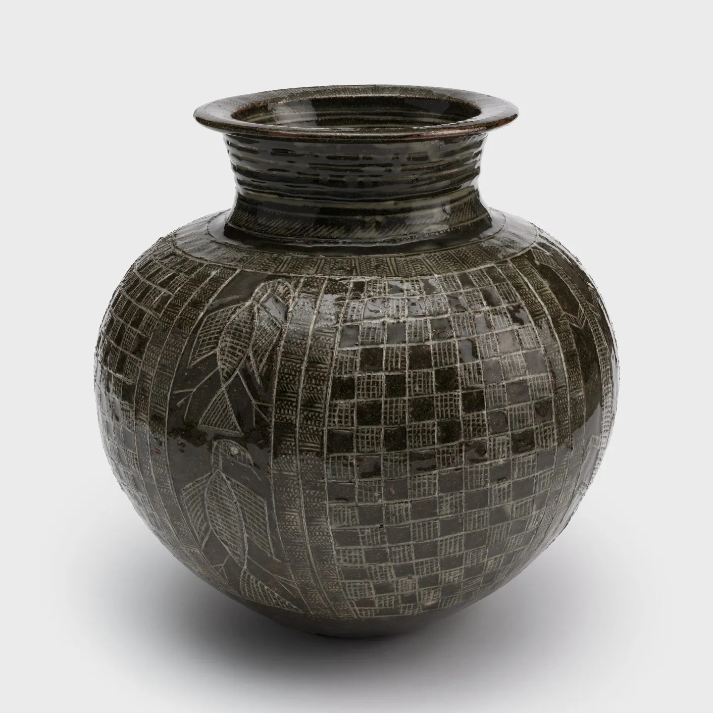 A clay pot with a tapered neck and a checkerboard pattern carved into the surface, along with designs of animals, including a lizard and a pair of birds.