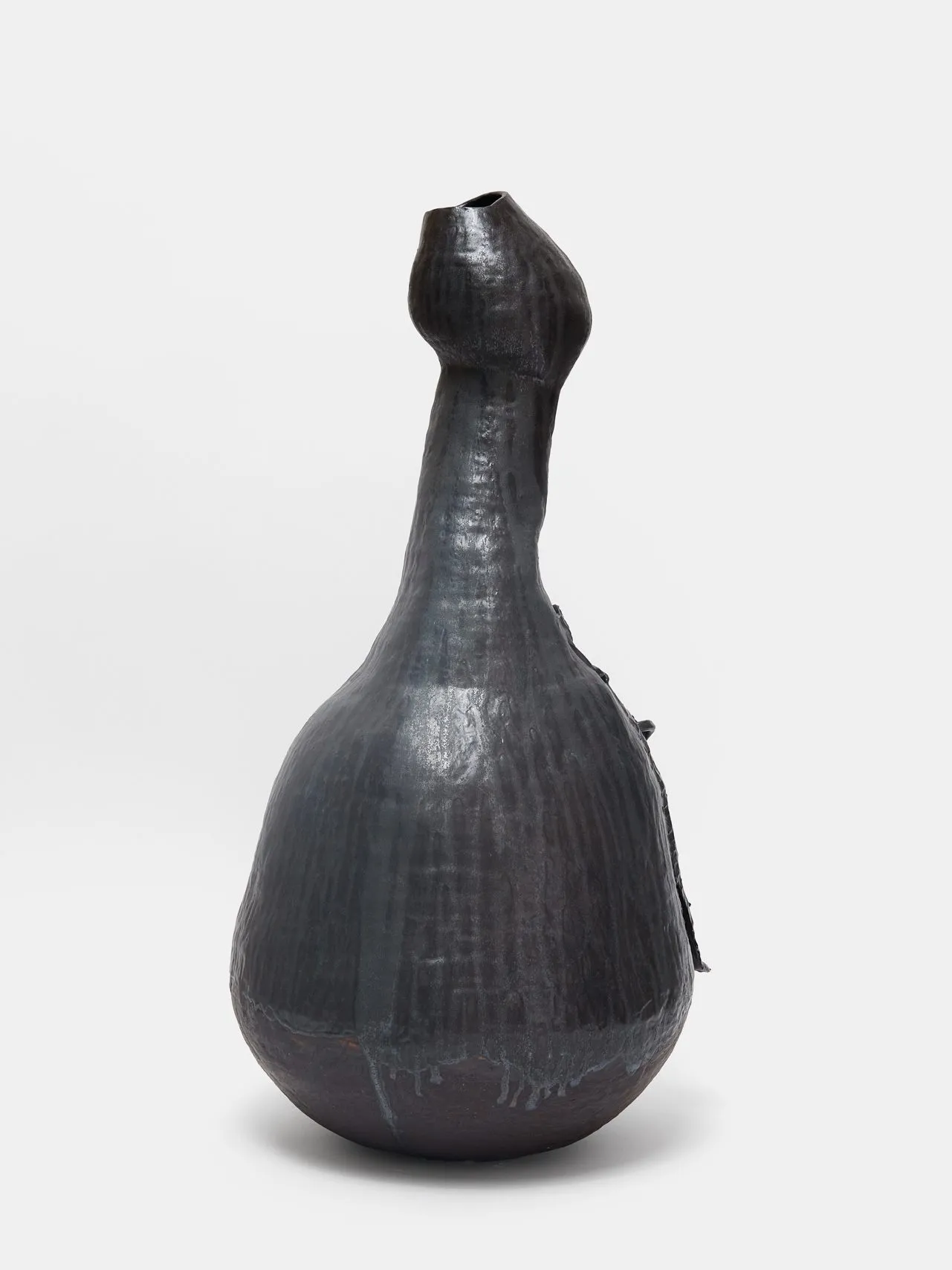 A ceramic sculpture with an oval body and long protruding neck, which bulges into an egg shape towards the opening. The vase is reminiscent of a gourd or goose.