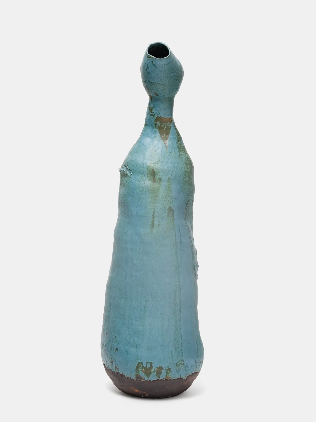 A teal colored ceramic sculpture with a long wine bottle-shaped body and neck, which bulges into an egg shape towards the opening.