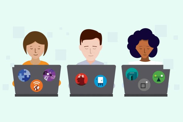 Individuals working on laptops against a green background