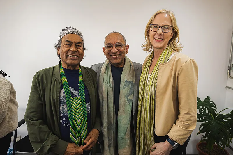 At the Conectas - Brazil and Democracy - Brazil in the world - event, Heather stands with two other individuals, one wearing a traditional beaded garment and one wearing a long green scarf.